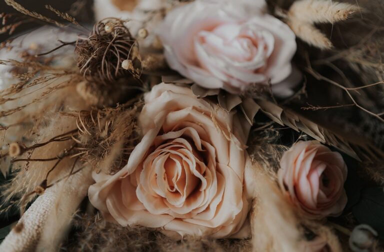 Close-up of a bouquet by Hidden Botanics that consists of blush pink roses and dried grasses